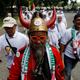 A Jokowi supporter wears a hat with horns in reference to the Indonesian Democratic Party of Struggle, whose logo is a red-eyed bull with curving horns.